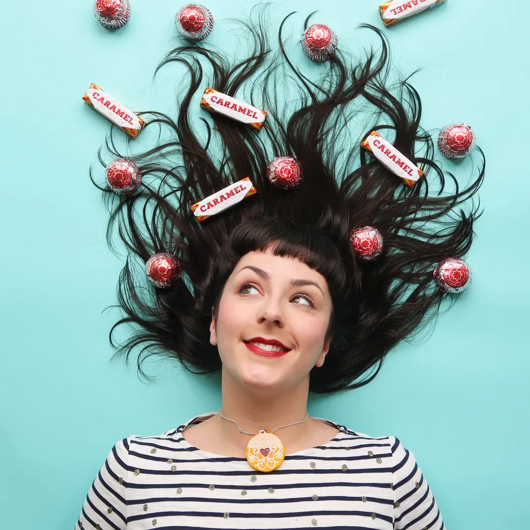 nikki lying down with her hair splayed out and biscuits on her hair