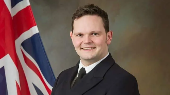 Andy Smart standing next to a Union Jack flag
