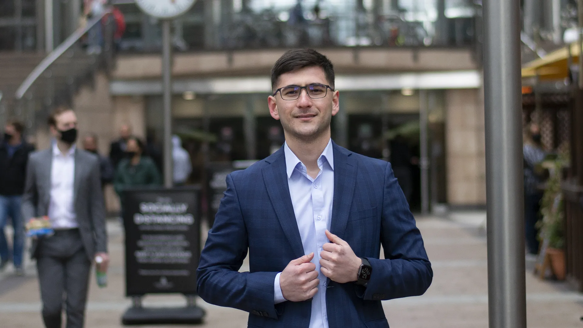 a man in a suit looking at the camera