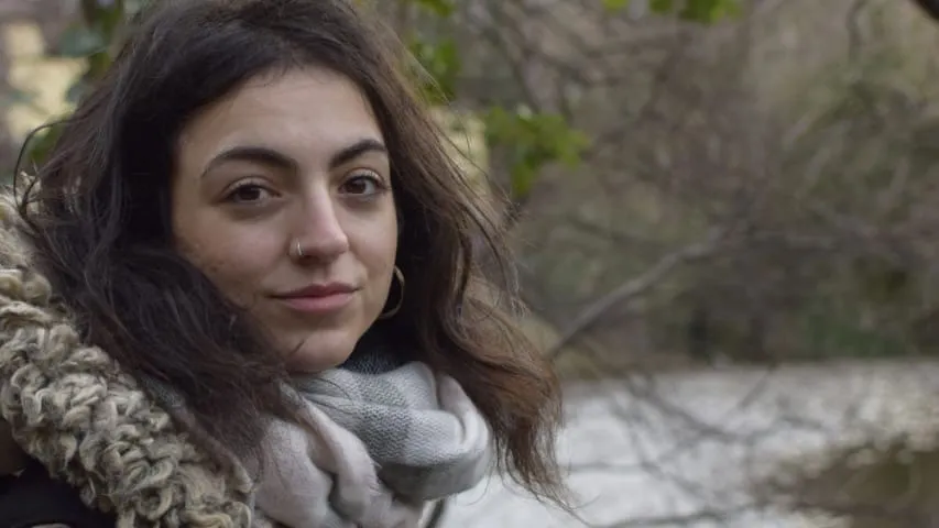 Aikaterini Damianidi with a river and trees in the background.