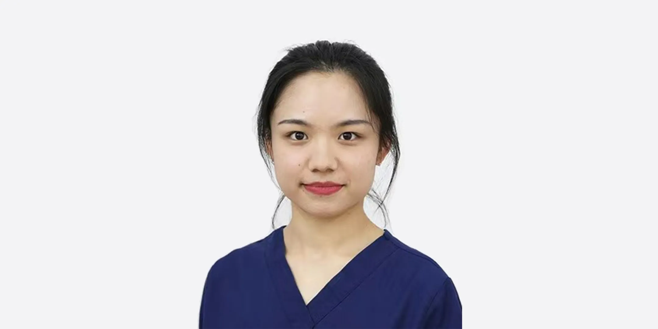 Qianyi Hong wearing blue and standing against a plain white background