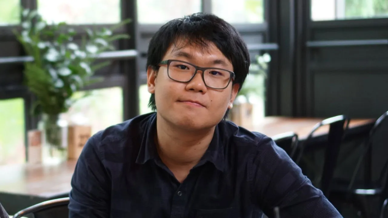 Pawat Piyakitcharoen is sitting in a cafe.