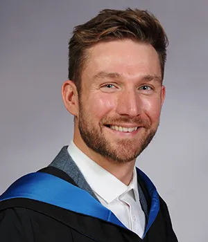 headshot of Ally Heather in graduation robes