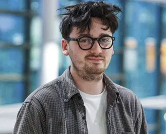 A portrait of Gareth, a man with dark hair and glasses.
