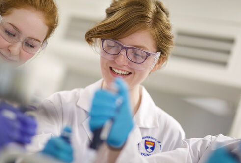 Two students working in a lab