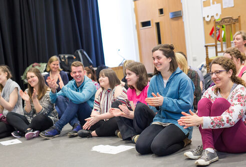 A group of people sitting on the floor