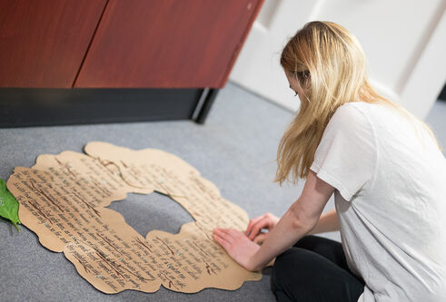 A woman making a cardboard model