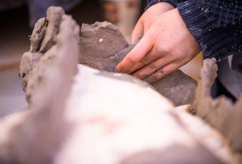 Pair of hands working with clay