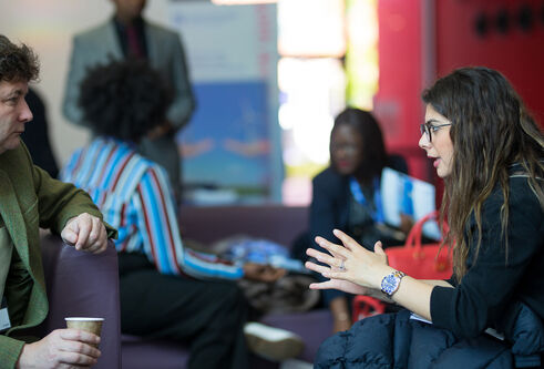 two people sitting and talking
