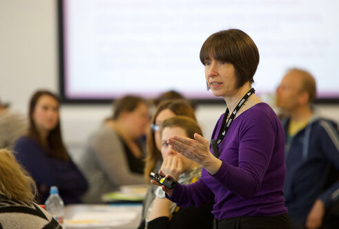 A teacher with a class of older students