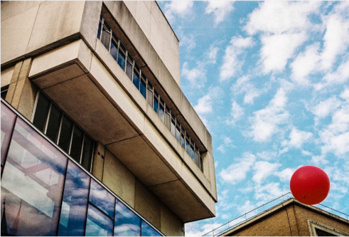 Concrete building with blue sky and clouds