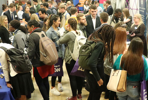 People wearing bags in crowded room