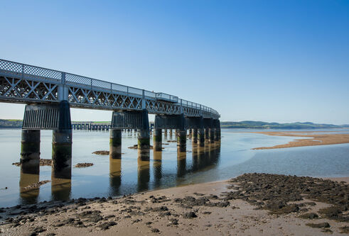 Tay Bridge on a sunny day with sandy shore nearby