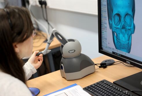 a student using a computer with facial imaging software