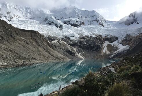 Snow capped mountains around a frozen lake