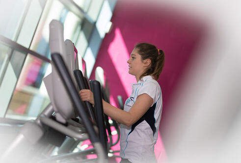 Girl using cross trainer at ISE