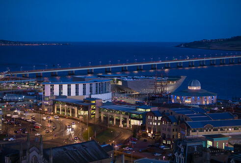 the waterfront at Dundee showing the city at night, and the tay road bridge