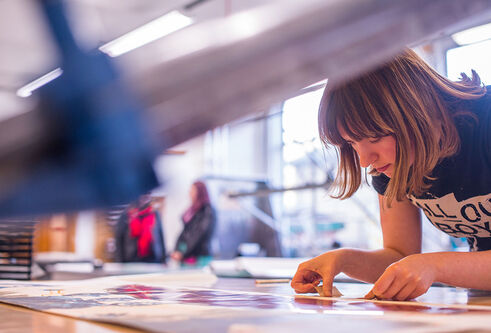 student using the printmaking facilities