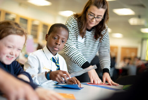 Student helping school pupils