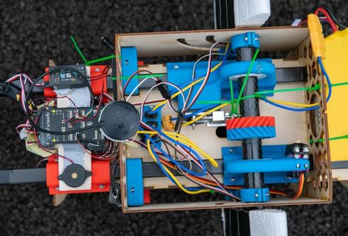 a look inside the machine with various wires and motors