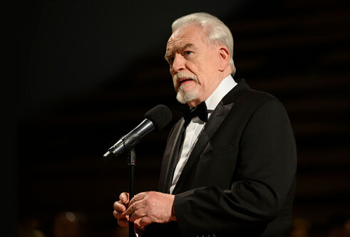 Brian Cox standing in front of a microphone