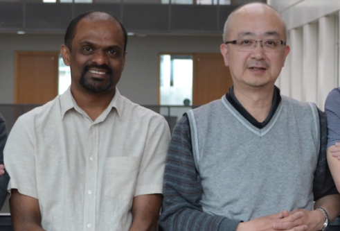 two male scientists standing together