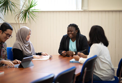 A group of students sitting round a table