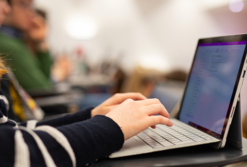 Student using a laptop in a lecture