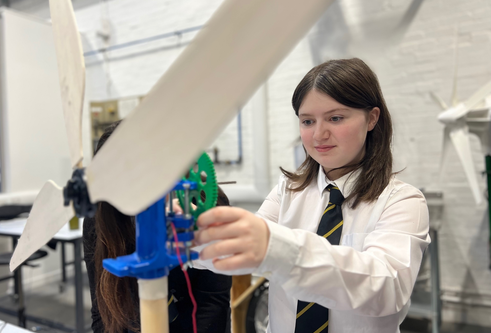 A pupil from Arbroath Academy building a mini wind turbine as part of an activity at the University of Dundee