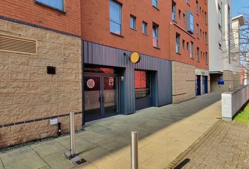 Path going along side a building, the entrance to the Centre for Entrepreneurship.