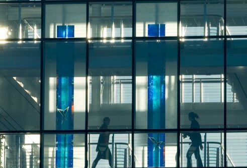 People can be seen through the windows of the Wellcome building.