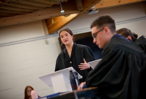 Graduate stood talking at the podium 