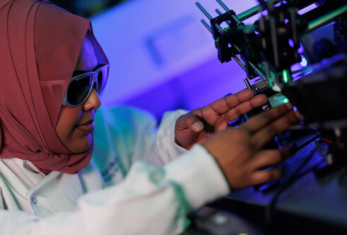 Researcher working in lab wearing protective glasses