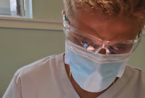 dental student working on a model head