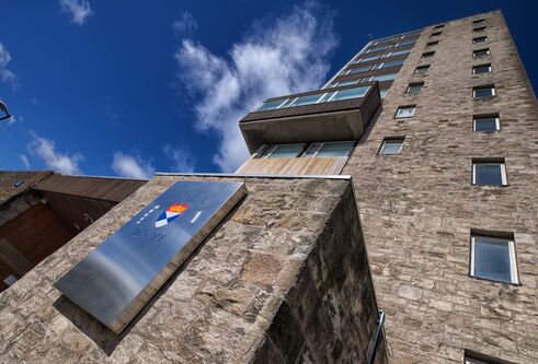 Tower building, looking up at the windows from the outside on sunny day. 