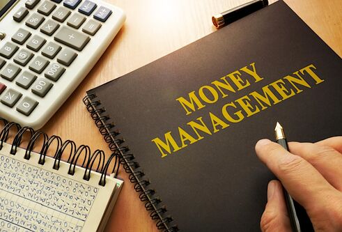 A notebook with Money Management on the front cover