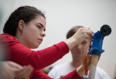 student working on a mechanical device