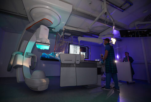 An individual standing in front of a huge mechanical device.