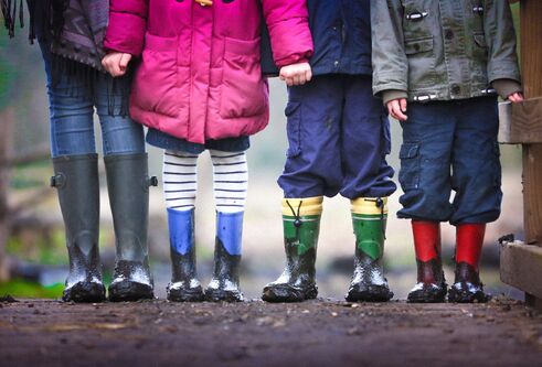 line of children, showing legs and welly boots