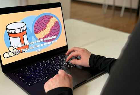 Leah works on a laptop