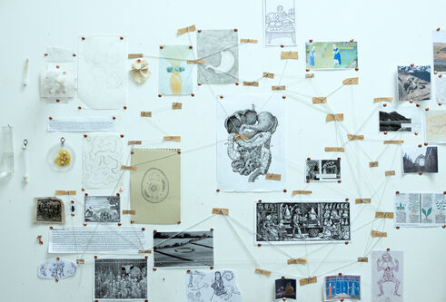 Selection of artwork and images on a wall