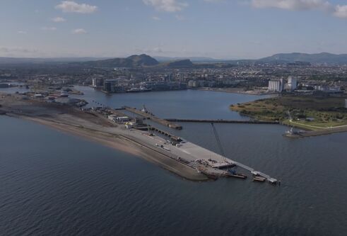 Ariel image of river and port, with city at the edge