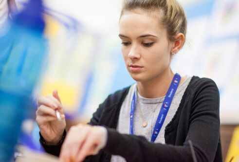 woman working as a teacher holding a pen in hand