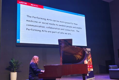 Woman playing piano on stage