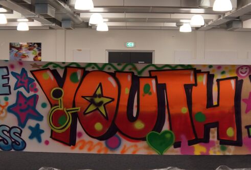 Graffiti on an outside wall, which says YOUTH