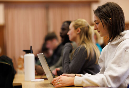 A group of students seated in a lecture theatre