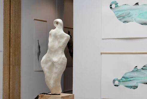 image of art exhibit, with a sculpture of a torso on the left hand side and two abstract art images on the right hand side, which are turquoise coloured shape