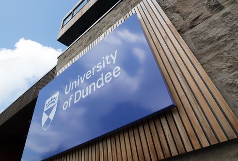 University of Dundee blue sign on tower building