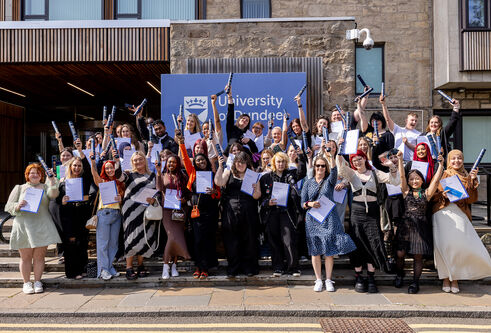 Access Summer School students standing at the steps of the Tower Building with their certificates