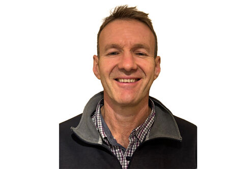 A head and shoulders photo of a man smiling